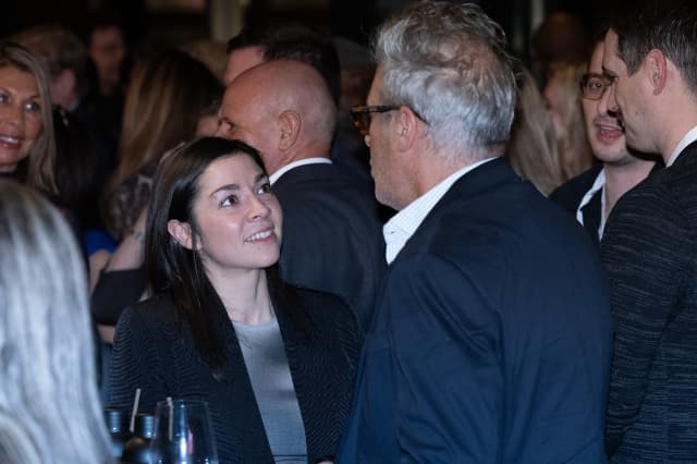 Two hospitality professionals having a conversation during a networking reception.